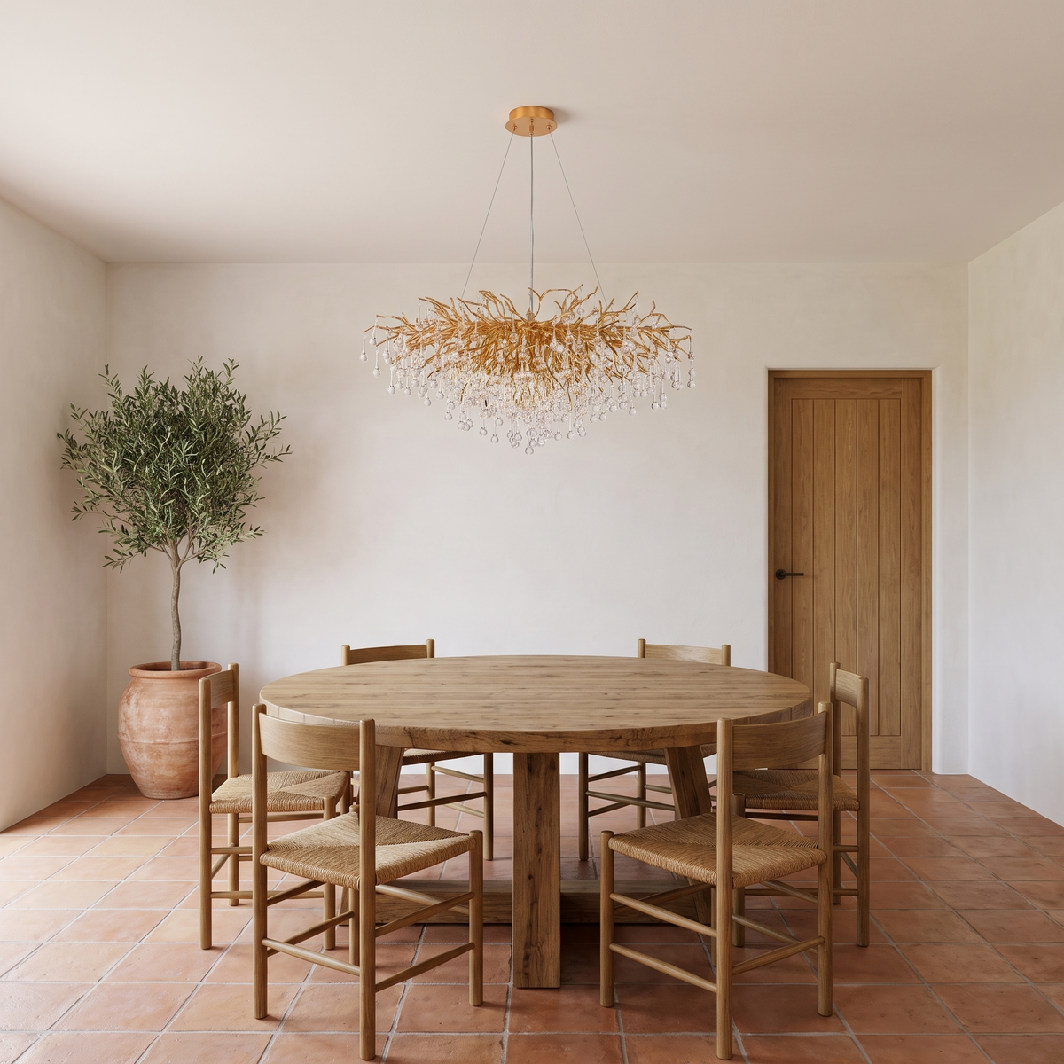 Bloomsbury crystal branch chandelier above a round oak table in a Mediterranean dining room