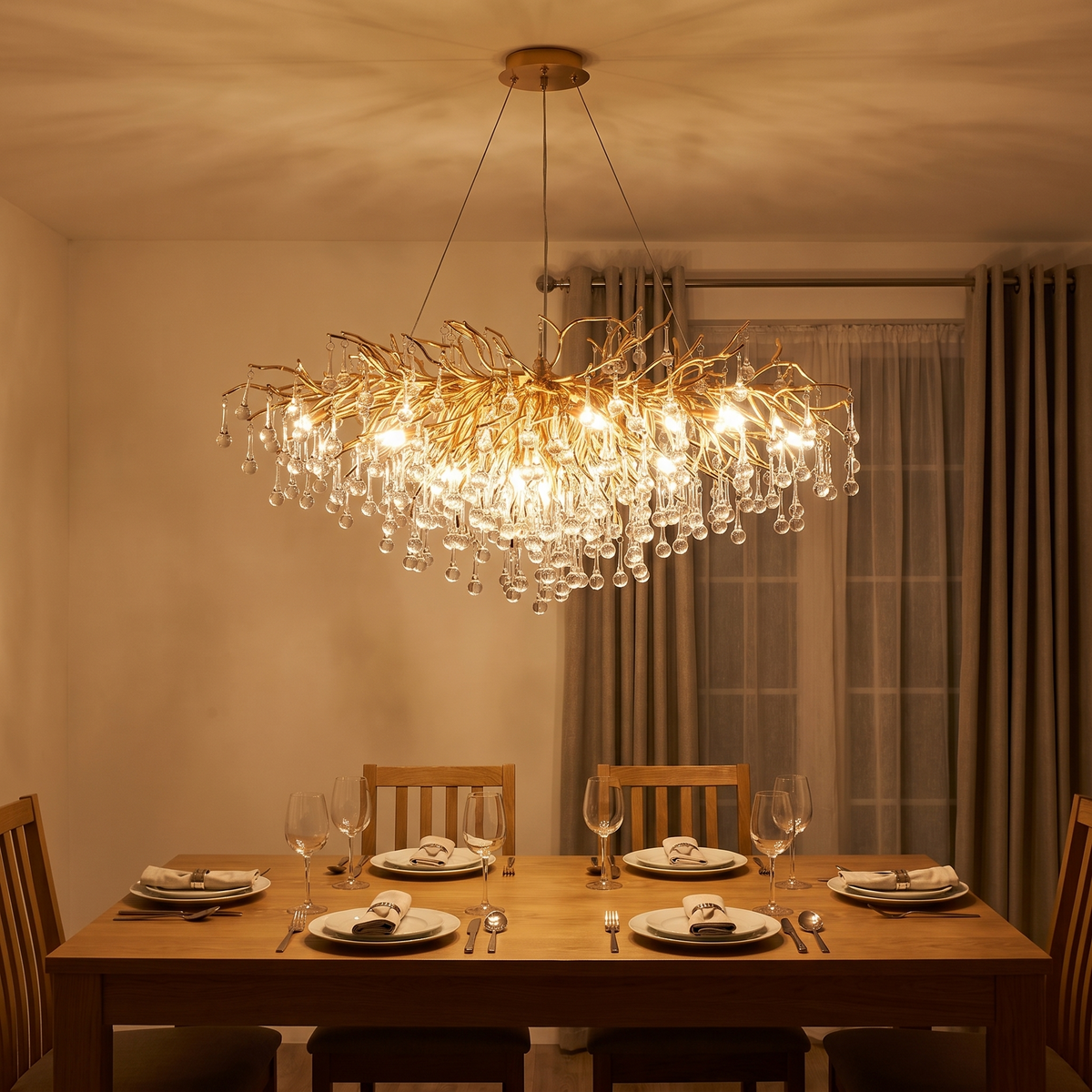 Bloomsbury crystal branch chandelier lit above a dining table in the evening