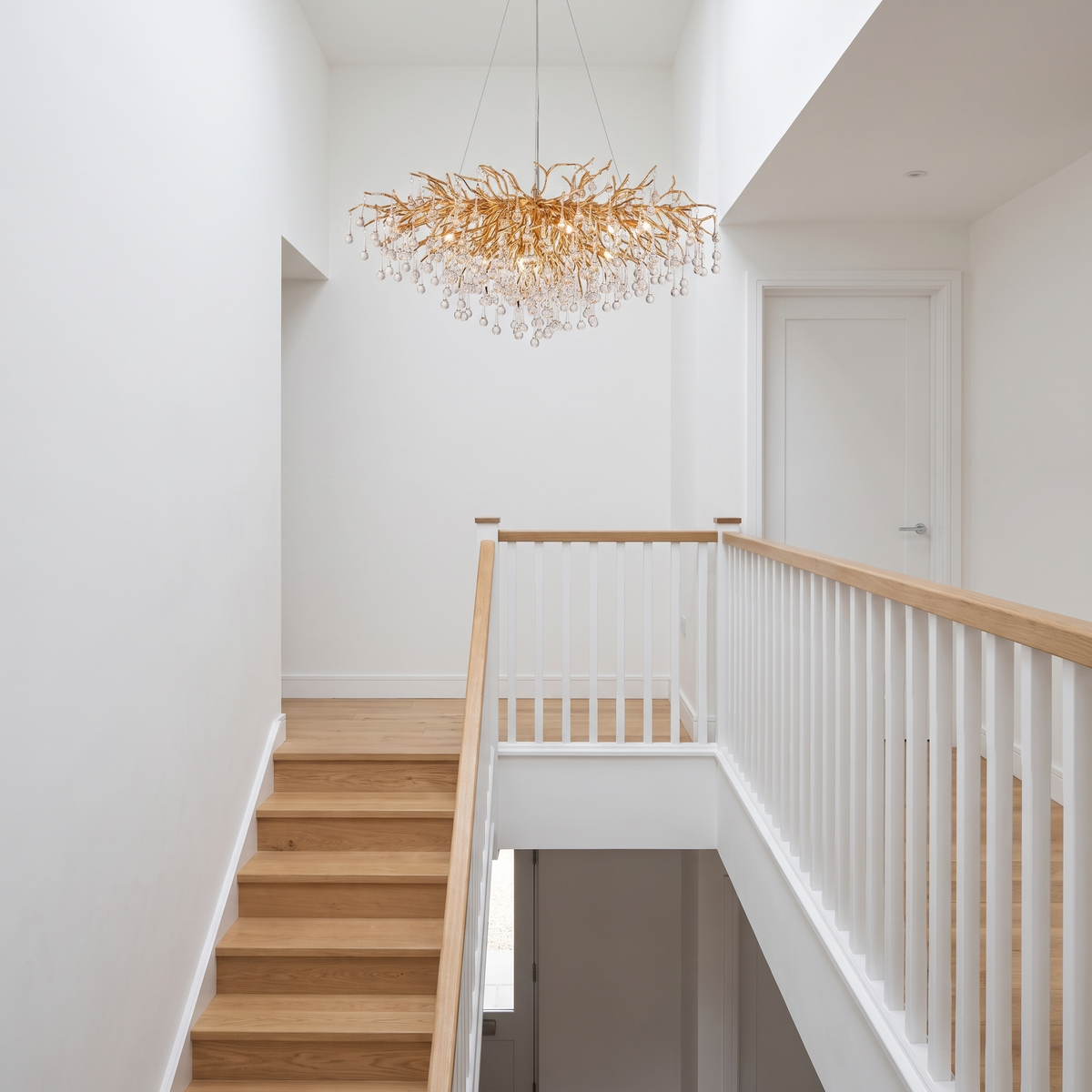 Bloomsbury crystal branch chandelier in a modern stairwell