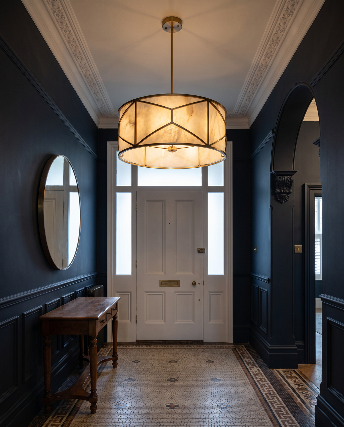 Clerkenwell round alabaster chandelier in brass in a dark blue period entrance hall