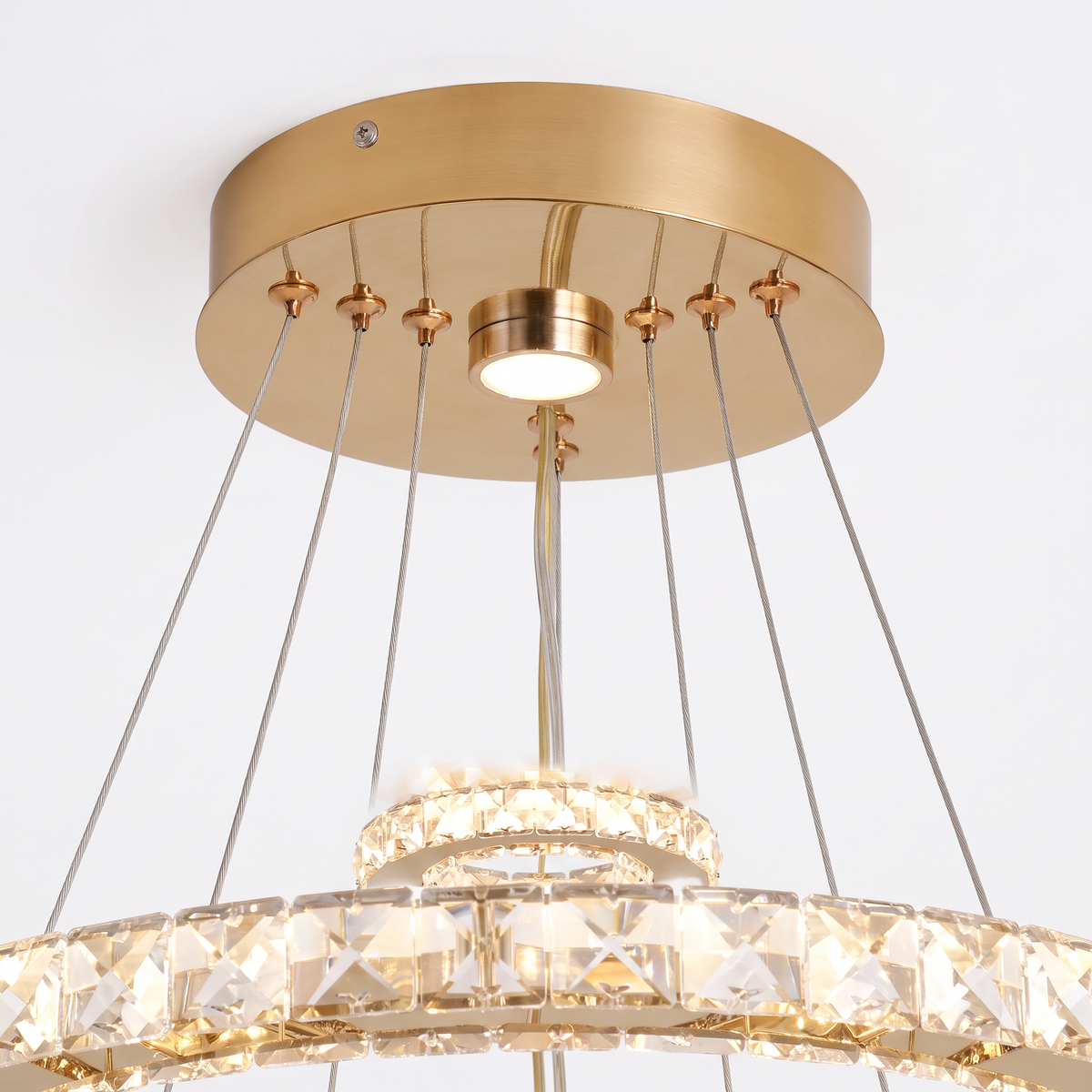 Clarence crystal ring pendant light, close-up of the gold ceiling canopy and cables