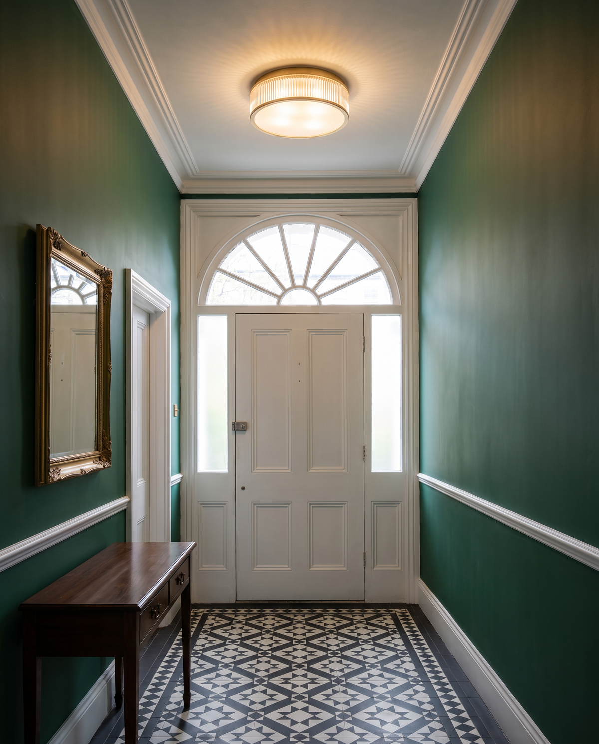 Holborn fluted glass flush ceiling light in brass in a period hallway
