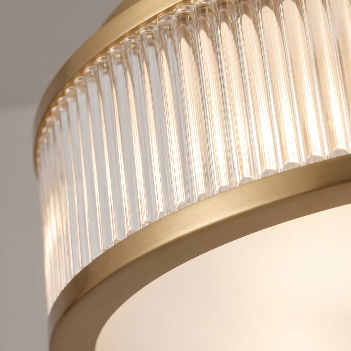 Holborn fluted glass flush ceiling light, close-up of the fluted glass ring and brushed gold frame