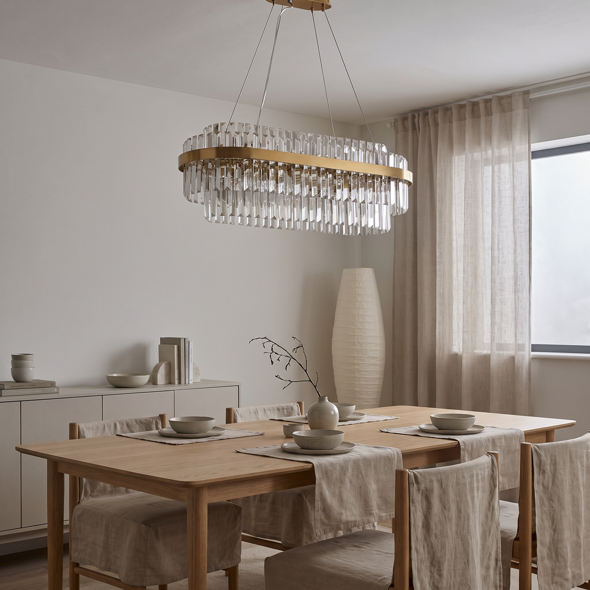 Mayfair tiered chandelier, oval crystal model above a dining table