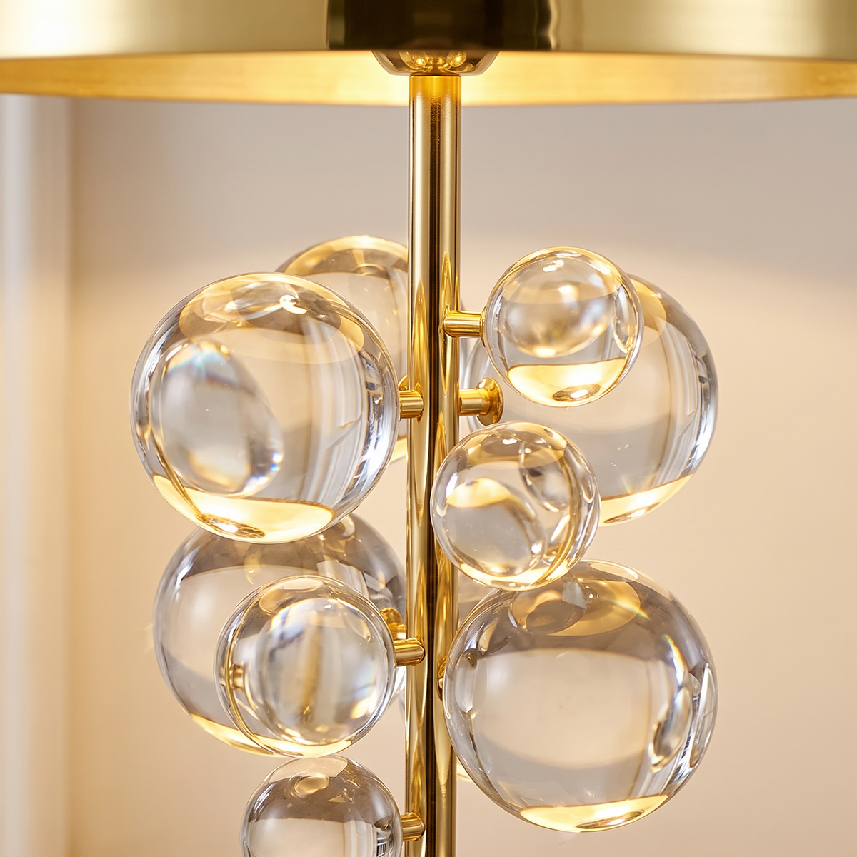 Primrose crystal globe table lamp, close-up of the clear crystal globes on the gold stem