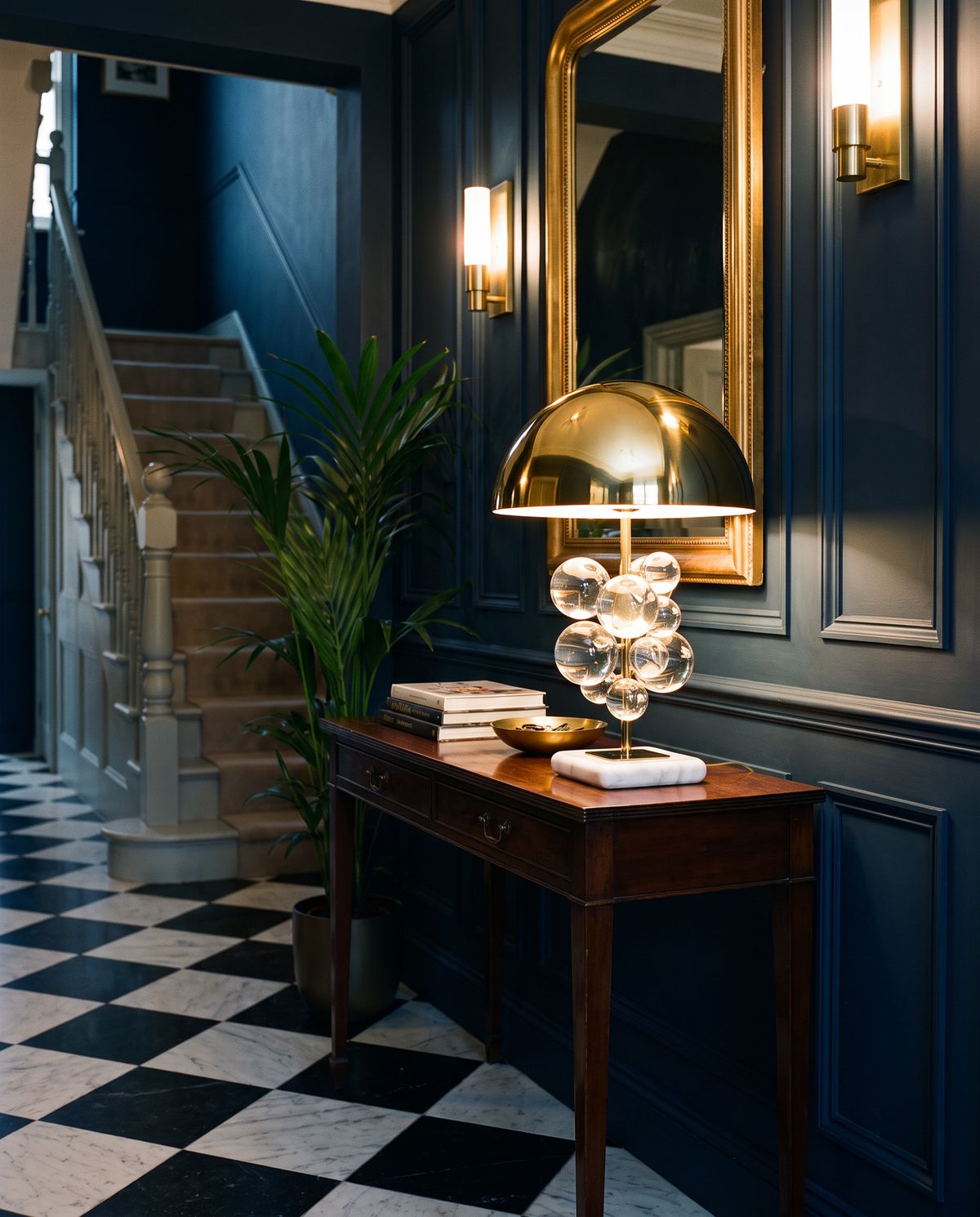 Primrose crystal globe table lamp, clear crystal, lit on a console in a midnight blue Georgian hallway