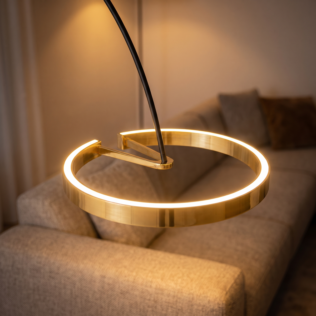 Richmond gold arc floor lamp, close-up of the glowing gold LED ring