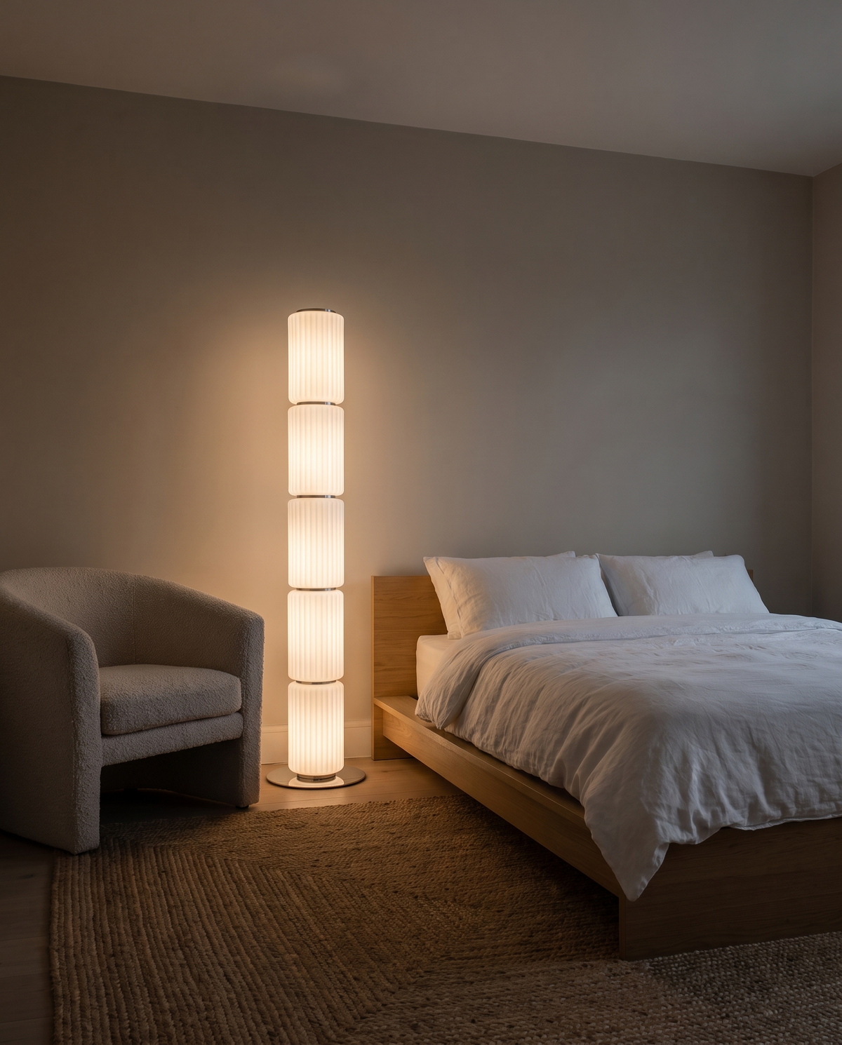 Barbican ribbed glass floor lamp in milk white, lit in a calm bedroom