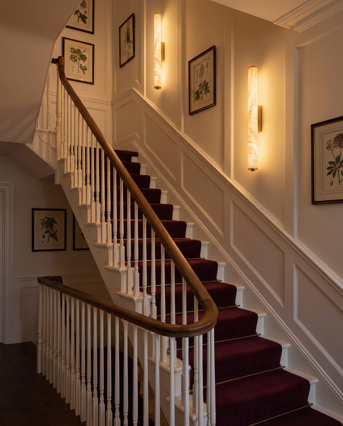 Belsize alabaster wall light, columns along a period staircase in the evening