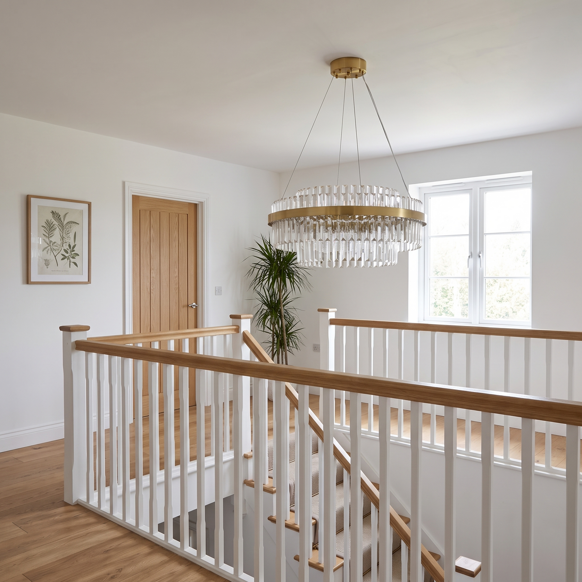 Mayfair tiered chandelier, round crystal model above an open stairwell landing