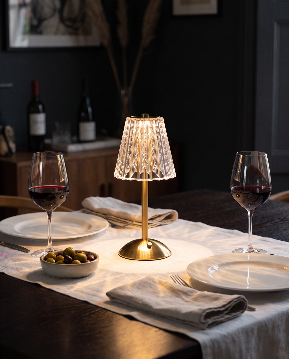 Piccadilly rechargeable crystal table lamp lit on a dinner table set for two