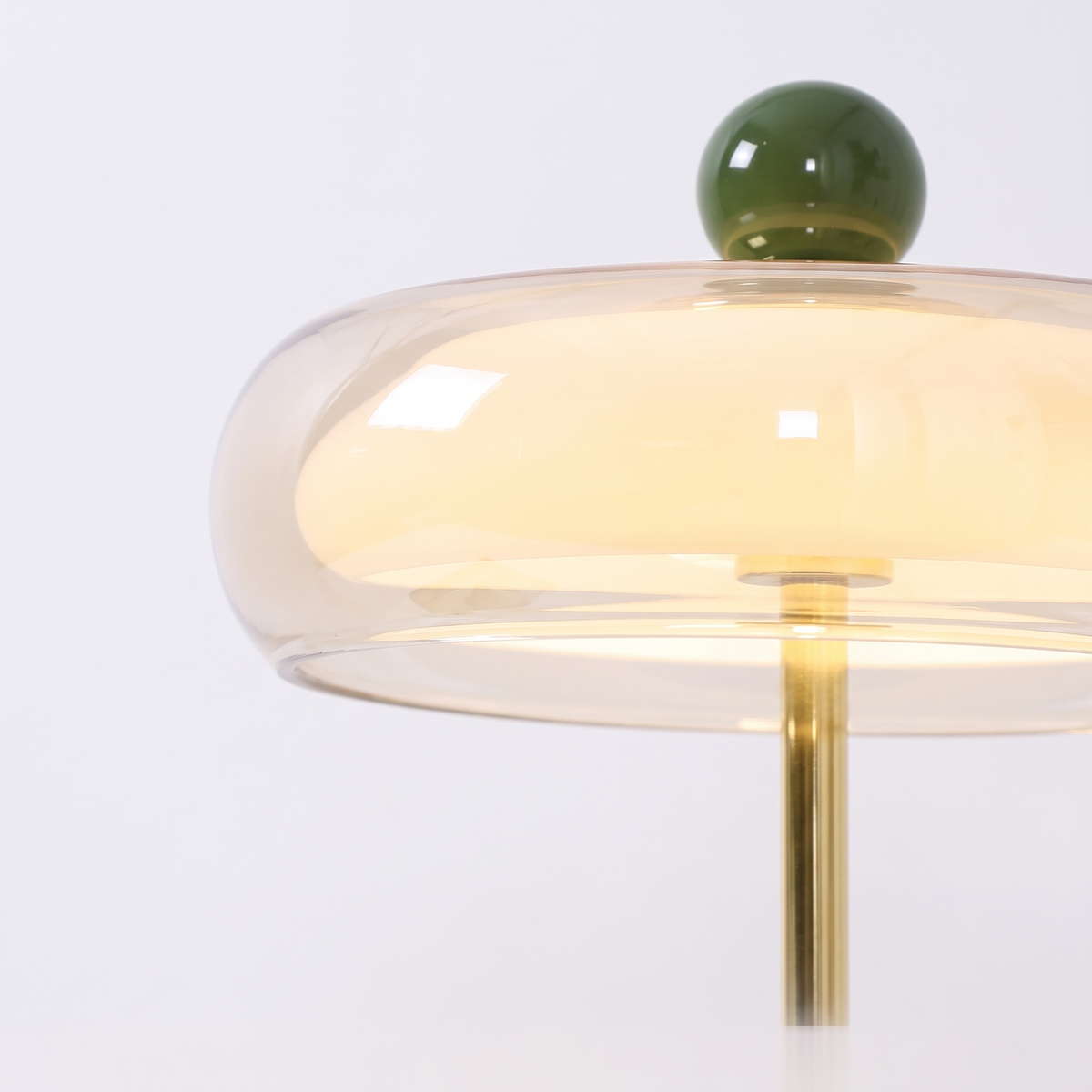 Portobello glass rechargeable table lamp, close-up of the clear glass disc shade and green ball
